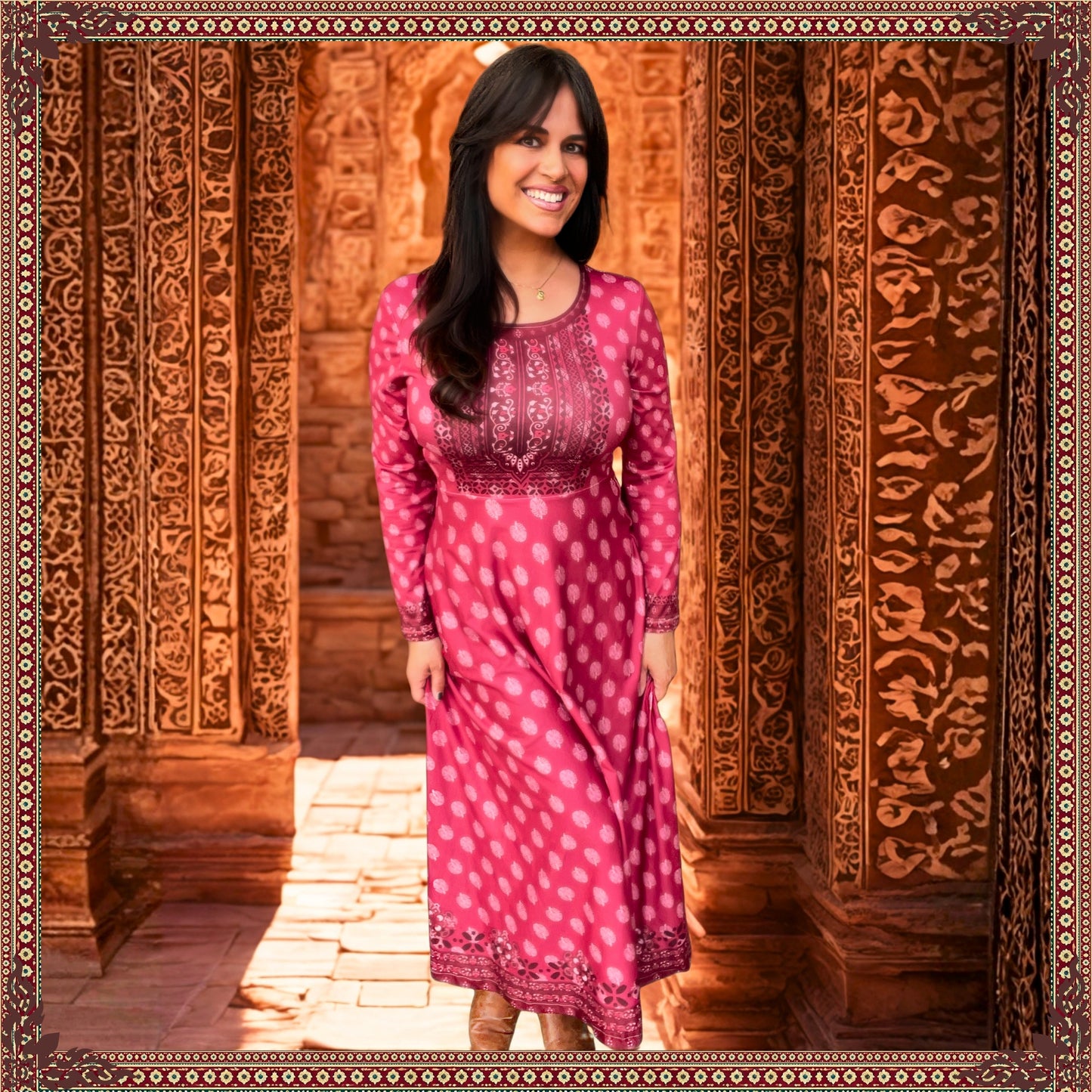 Woman wearing the Rani Rouge Jaipur Kurta Dress, a red-pink bohemian maxi dress by FAVIE, standing in front of ornate Jaipur-inspired architecture.
