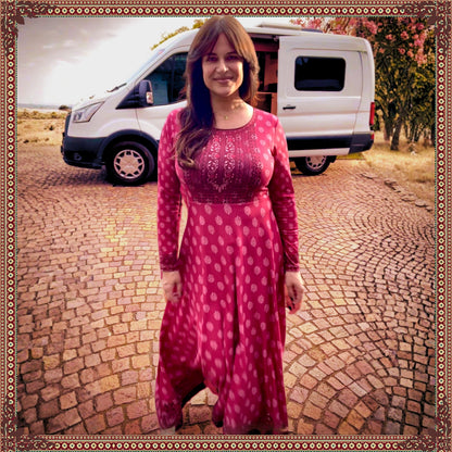 Woman wearing the Rani Rouge Jaipur Kurta Dress by FAVIE while walking outdoors near a camper van, showcasing the flowing red-pink bohemian maxi dress.
