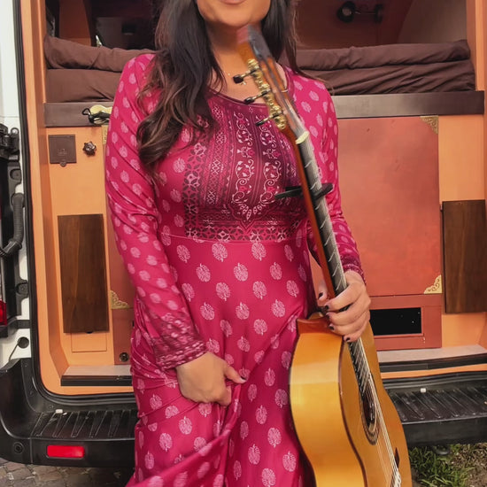 Video of a woman wearing the Rani Rouge Jaipur Kurta Dress, a red-pink bohemian maxi dress with original FAVIE artwork.